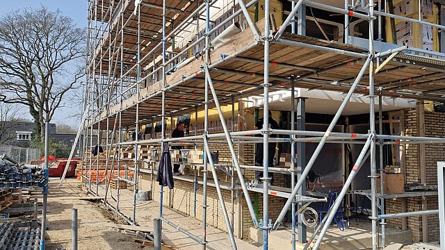 Een woning in de steigers waar gebouwd wordt